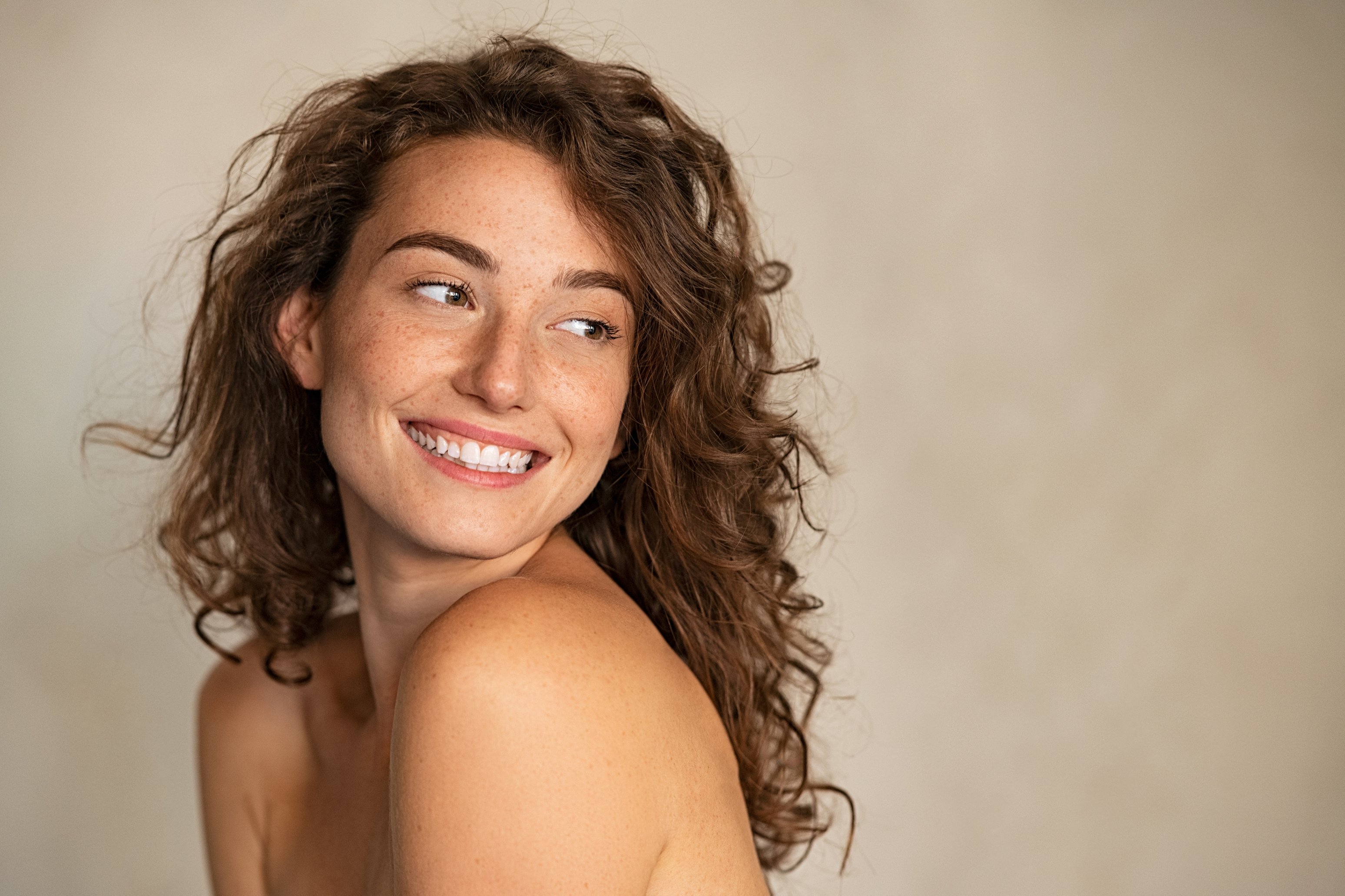 Smiling Woman with Freckles Looking Away